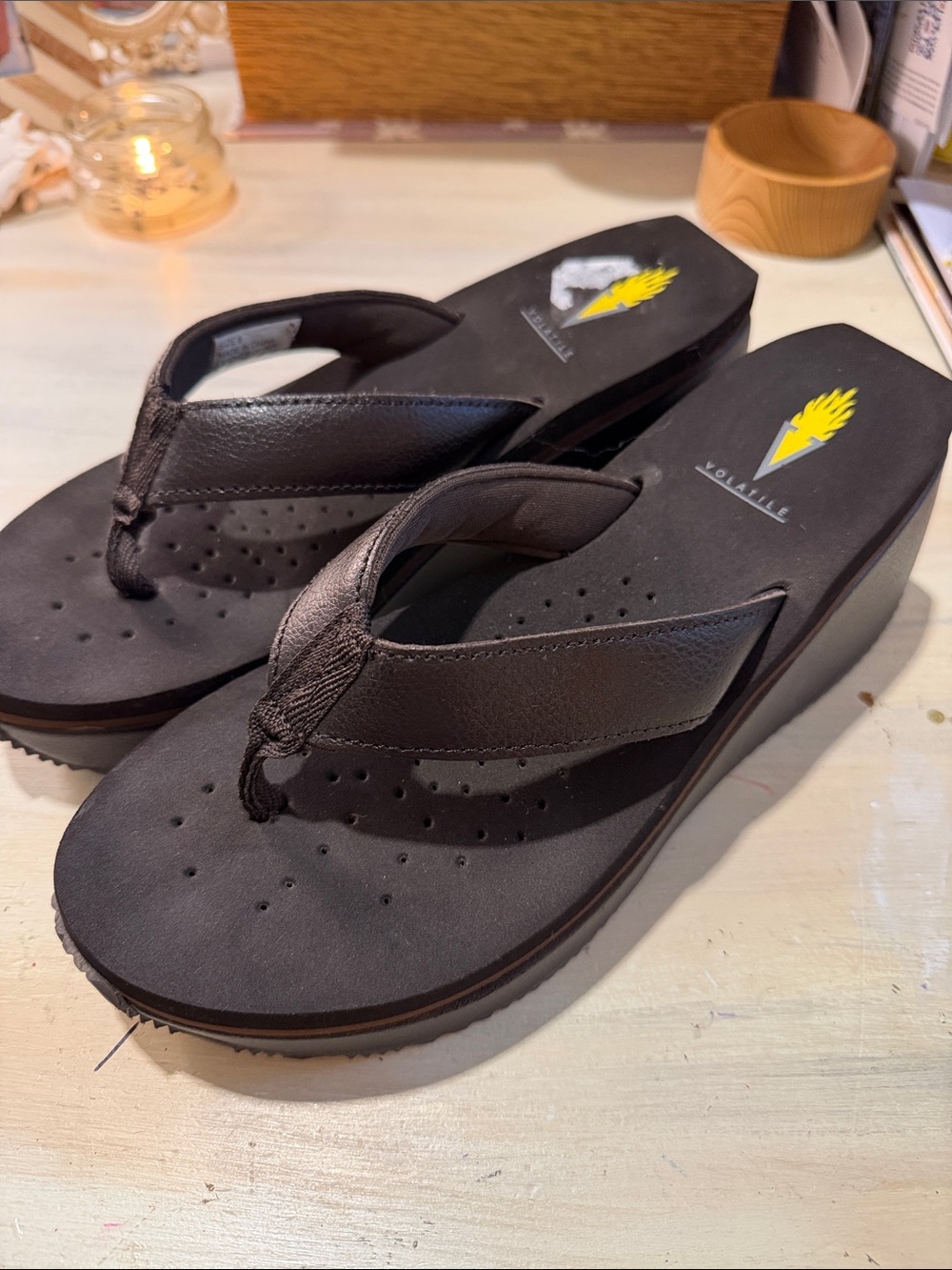 Volatile brown Wedge Flip Flops with Yellow Logo Accent